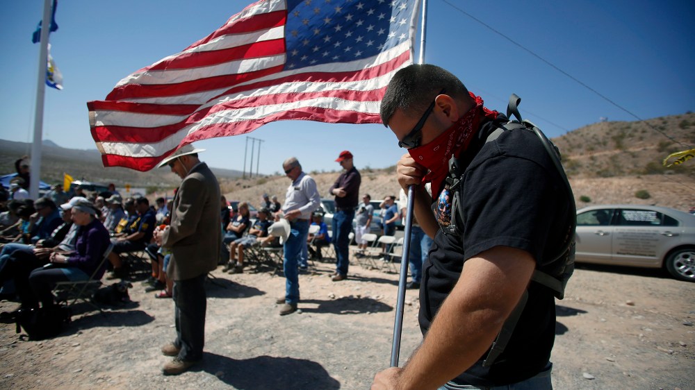 A protestor prays during a roadside church service at a protest site in Bunkerville, Nevada