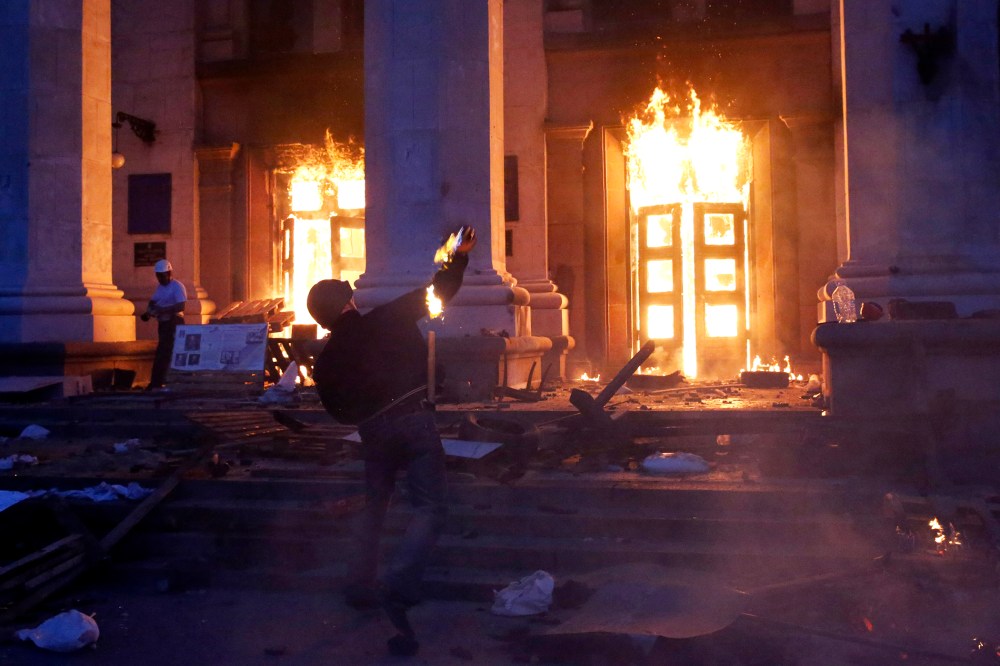A protester throws a petrol bomb at the trade union building in Odessa May 2, 2014.