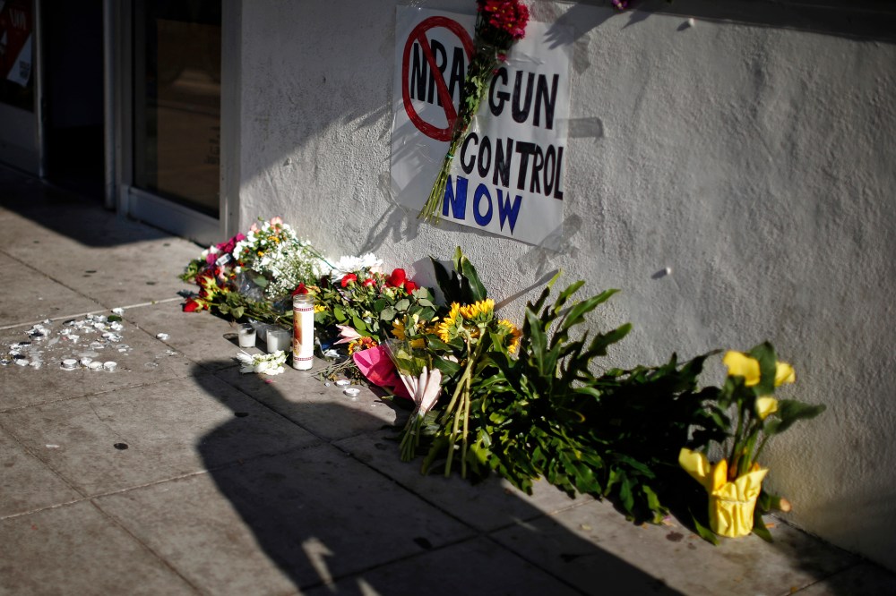 A sign advocating gun control is seen on a makeshift memorial for UCSB student Christopher Michael-Martinez in Isla Vista