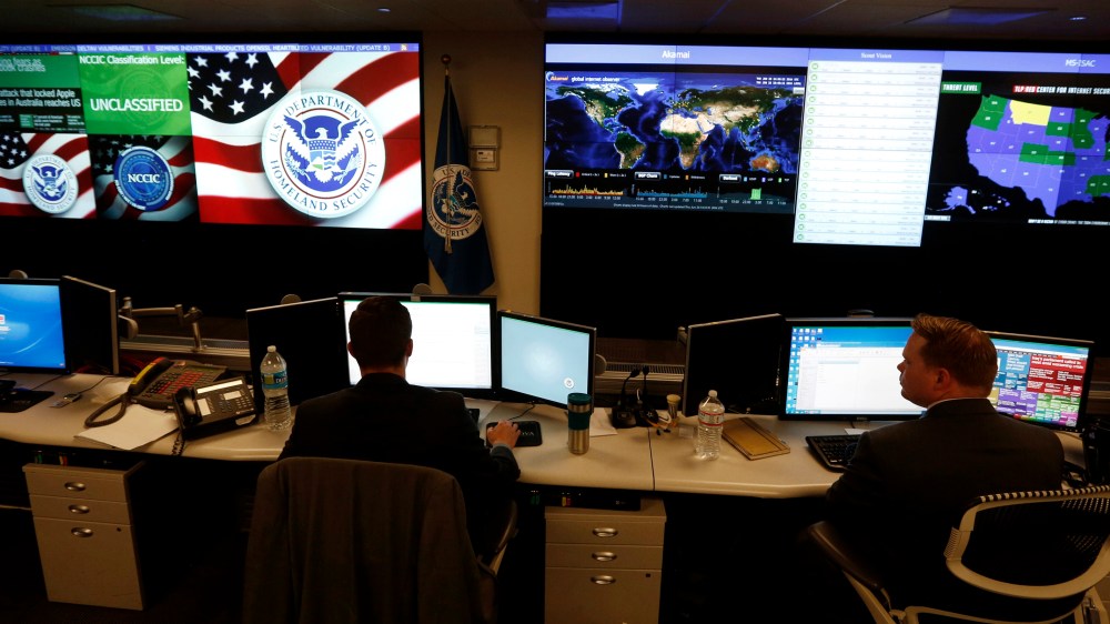US Department of Homeland Security employees work in front of US threat level displays inside the National Cybersecurity and Communications Integration Center as part of a guided tour in Arlington, Va. June 26, 2014. (Photo by Kevin Lamarque/Reuters)