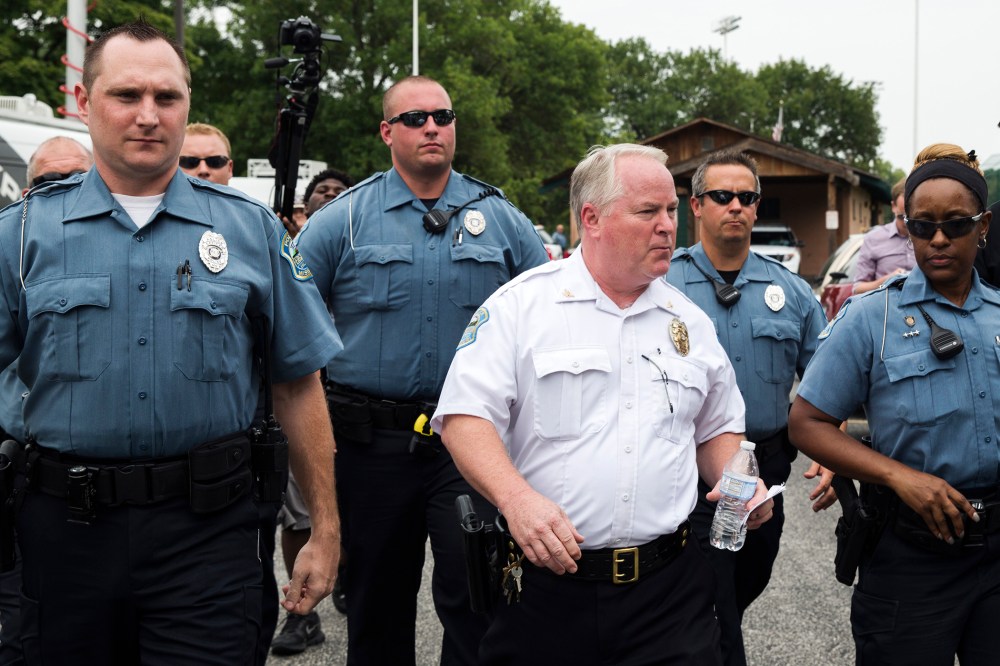 Ferguson Police Chief Thomas Jackson (C) walks away from a media availability in Ferguson, Mo on Aug. 15, 2014. (Photo by Lucas Jackson/Reuters)