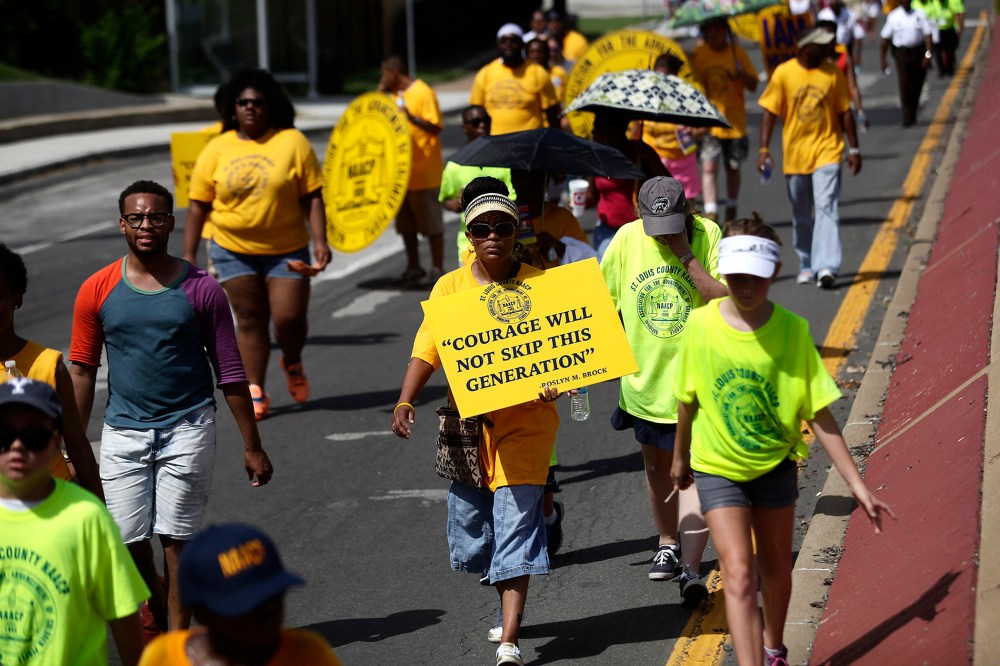 Demonstrators protest the shooting of Michael Brown in Ferguson, Mo., Aug. 23, 2014.