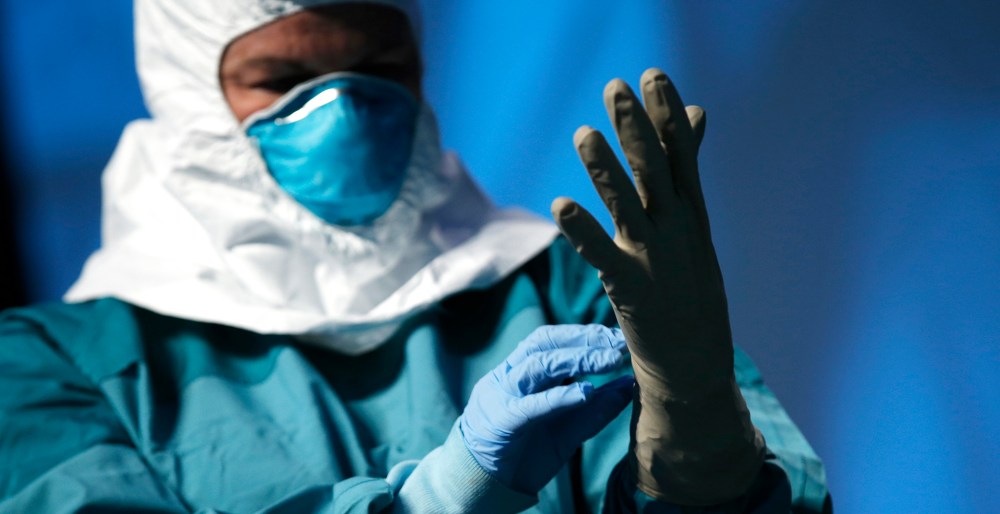 A registered nurse in New York, demonstrates putting on personal protective equipment (PPE) during an Ebola educational session for healthcare workers in New York, Oct. 21, 2014. (Photo by Mike Segar/Reuters)