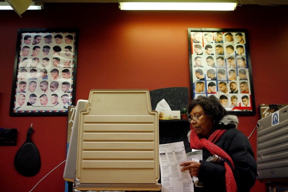 A voter casts her ballot for the U.S. midterm elections at a beauty salon used as a polling station in Chicago on Nov. 4, 2014
