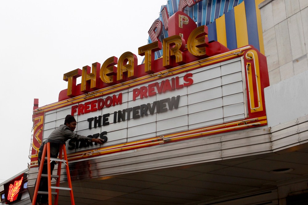 General Manager Delaney puts letters on the marquee sign after the announcement that the Plaza Theatre would be showing the movie "The Interview" in Atlanta