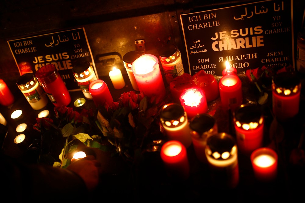 People light candles to pay tribute to victims during a vigil in Frankfurt on Jan. 8, 2015, following a shooting by gunmen at the offices of weekly satirical magazine Charlie Hebdo in Paris. (Photo Kai Pfaffenbach/Reuters)