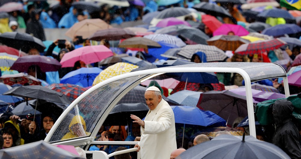 Pope Francis waves as he arrives to lead the weekly audience in Saint Peter's square at the Vatican March 25, 2015. (Photo by Stefano Rellandini/Reuters)