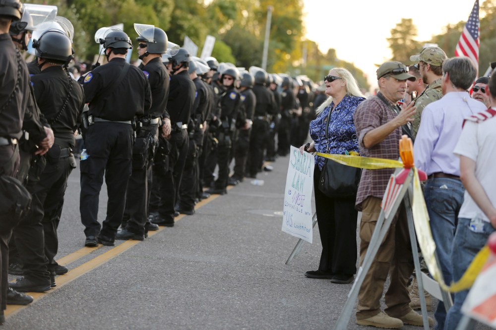 A police line separates people attending the "Freedom of Speech Rally Round II" from counter demonstrators outside the Islamic Community Center in Phoenix, Ariz. on May 29, 2015. (Photo by Nancy Wiechec/Reuters)
