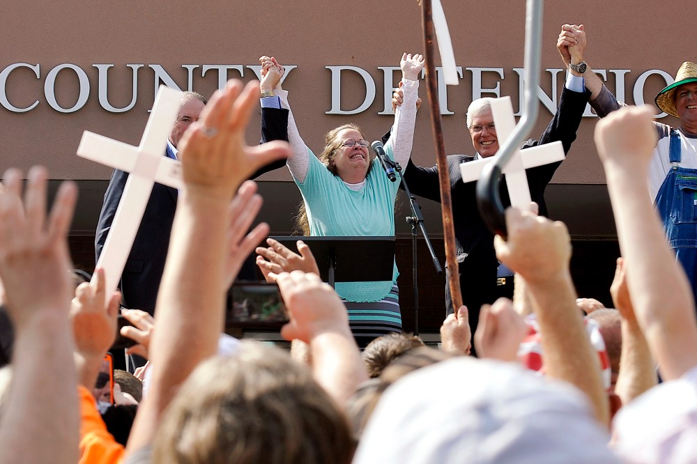Kim Davis, flanked by Mike Huckabee, her attorney and her husband, celebrates after her release from the Carter County Detention center in Grayson, Ky., Sept. 8, 2015. (Photo by Chris Tilley/Reuters)