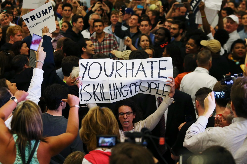 A protestor holds up a sign reading "Your Hate is Killing People" in the midst of Donald Trump's campaign rally in New Orleans, La., March 4, 2016. (Photo by Stringer/Reuters)