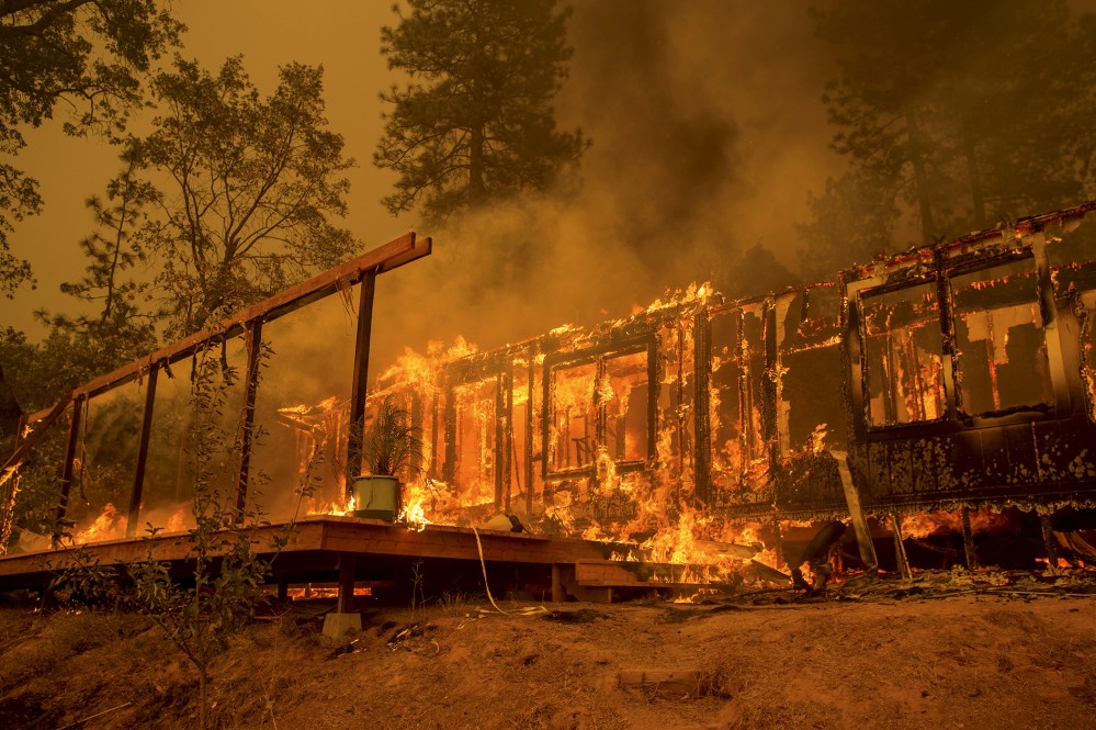 A home burns as the Butte Fire rages near Mountain Ranch, Calif., Sept. 11, 2015. (Photo by Noah Berger/Reuters)