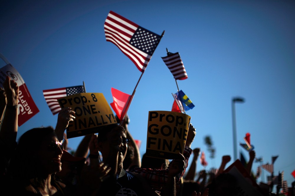 People wave U.S. and marriage equality flags in West Hollywood, Calif. after the United States Supreme Court ruled on California's Proposition 8 and the federal Defense of Marriage Act June 26, 2013.