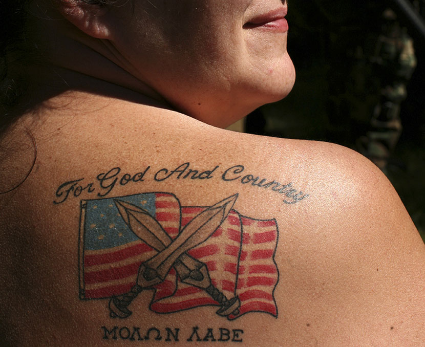 Female soldier from the 63rd battalion from Spokane, Washington, displays her tattoo during the Light Foot Militia annual gathering on Bureau of Land Management land near Priest River, Idaho June 23, 2013.  (Photo by Matt Mills/AP)