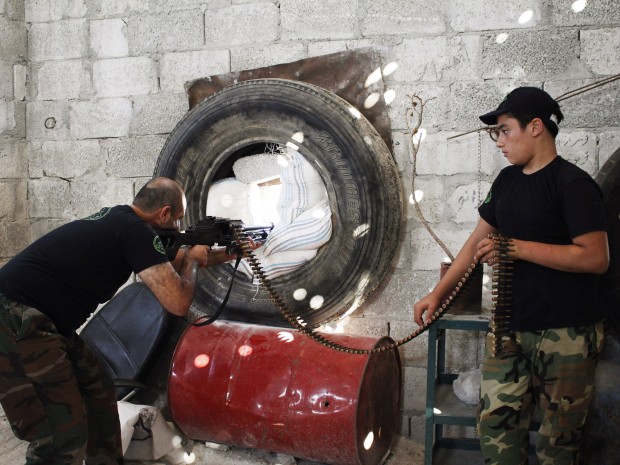 A Free Syrian Army fighter points weapon - Abby Borowitz - 09/3/2013