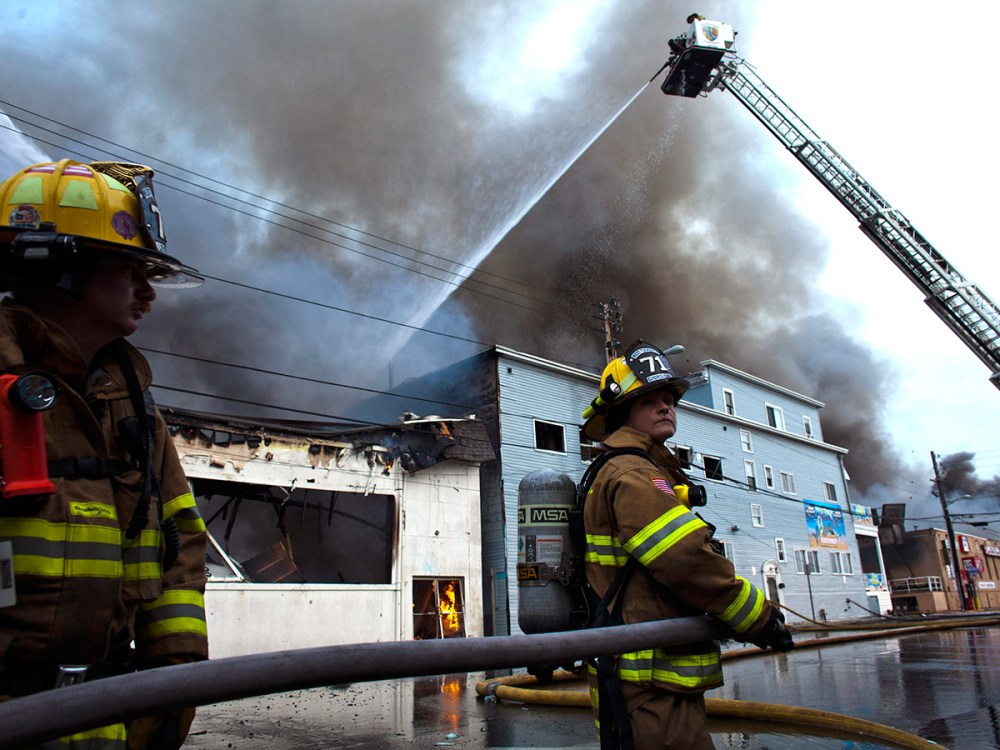 New Jersey firefighters spray water as they try to control a massive fire in Seaside Park in New Jersey