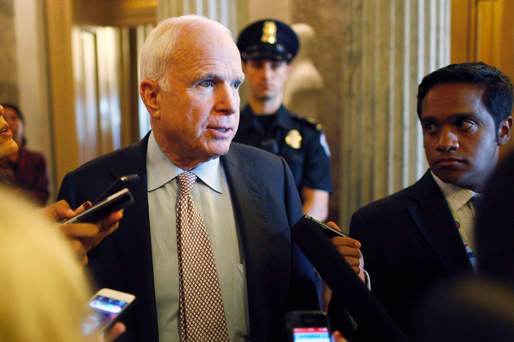 U.S. Senator John McCain talks to reporters as the Senate passes a spending bill to avoid a government shutdown at the U.S. Capitol in Washington on Sept. 27, 2013.