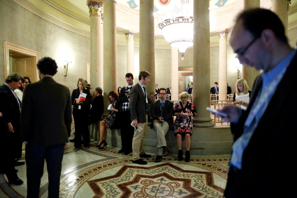Reporters gather outside of a Republican Senate caucus meeting and wait for senators' remarks at the U.S. Capitol in Washington October 16, 2013.