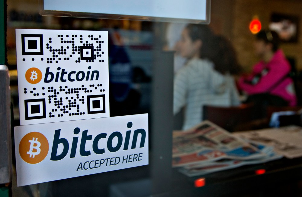 Signs on window advertise a bitcoin ATM machine that has been installed in a Waves Coffee House in Vancouver, British Columbia October 28, 2013.