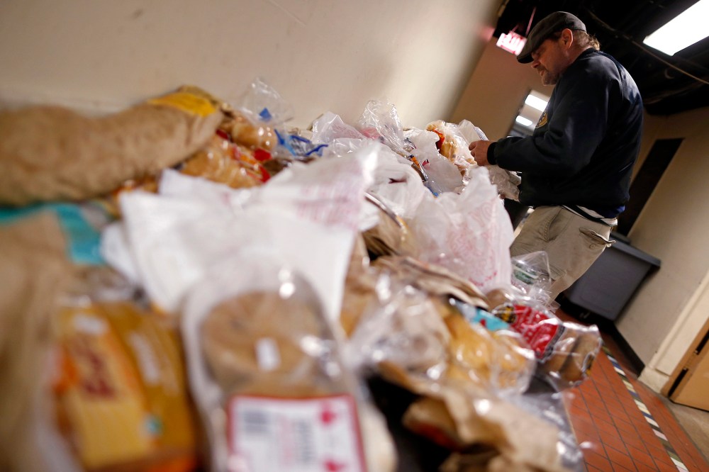 Frank Doyle looks over a table of food at the Emergency Assistance Program at the Chicago Catholic Charities in Chicago