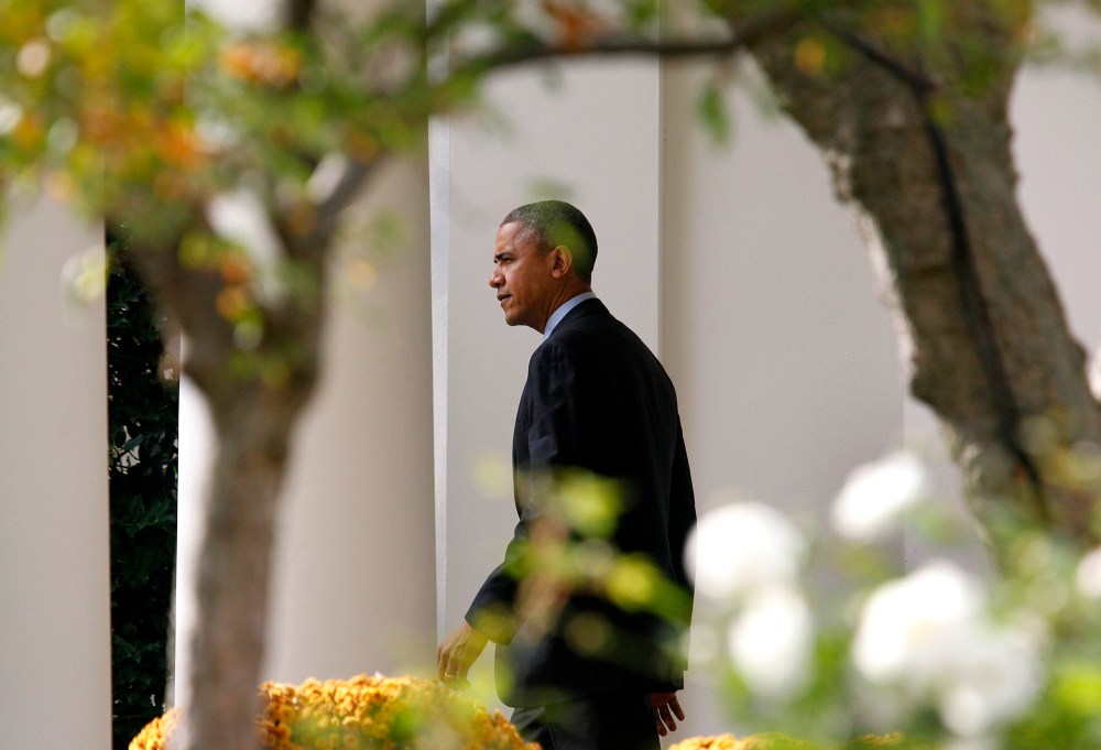 U.S. President Barack Obama walks out from the Oval Office of the White House in Washington before his departure to the Walter Reed National Military Medical Center