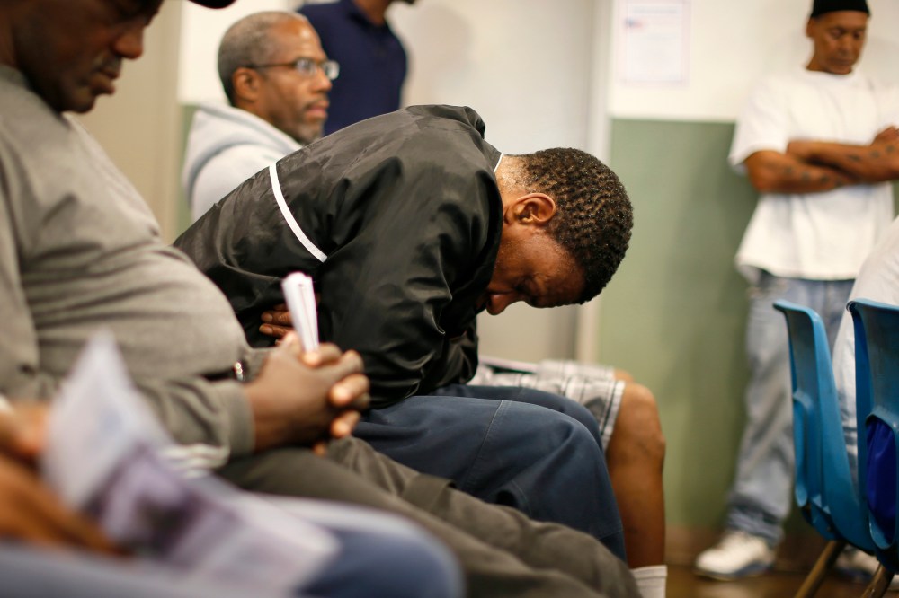 U.S. military veterans listen to speeches during a Veterans Day observance for homeless veterans at The Midnight Mission shelter in Los Angeles, Nov. 11, 2013.
