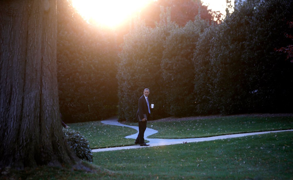 U.S. President Barack Obama walks to the Oval Office of the White House on November 19, 2013.
