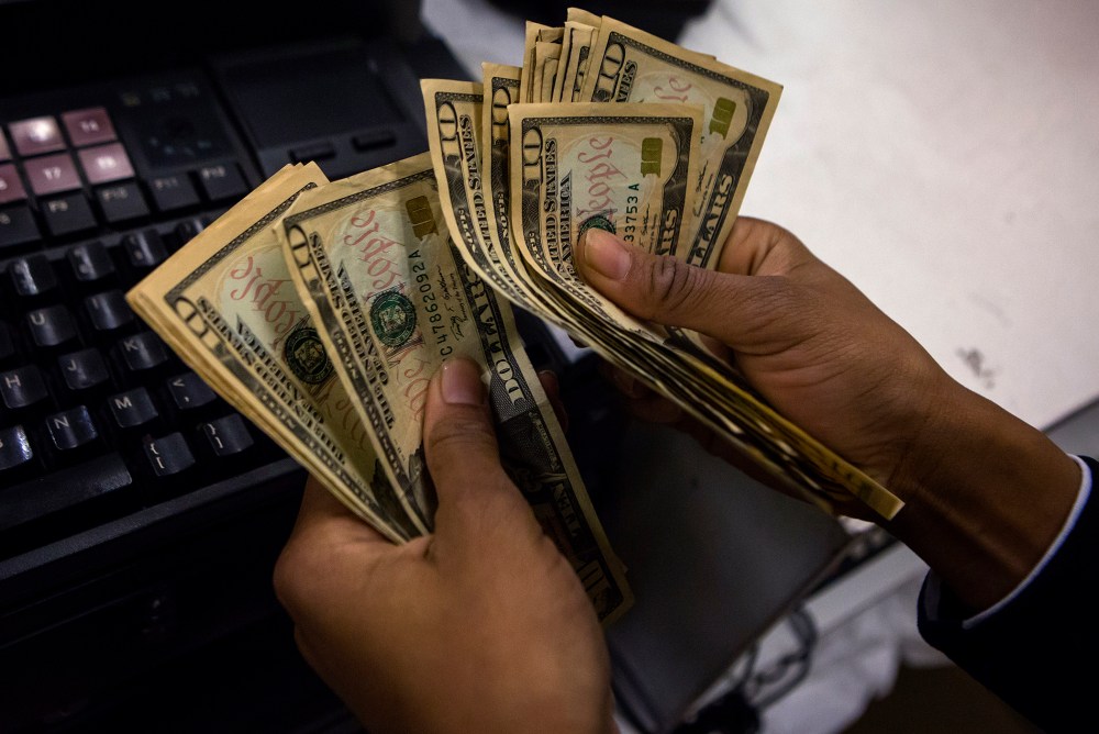 A cashier counts out money at Macy's Herald Square on Thanksgiving Day in New York, Nov. 28, 2013.