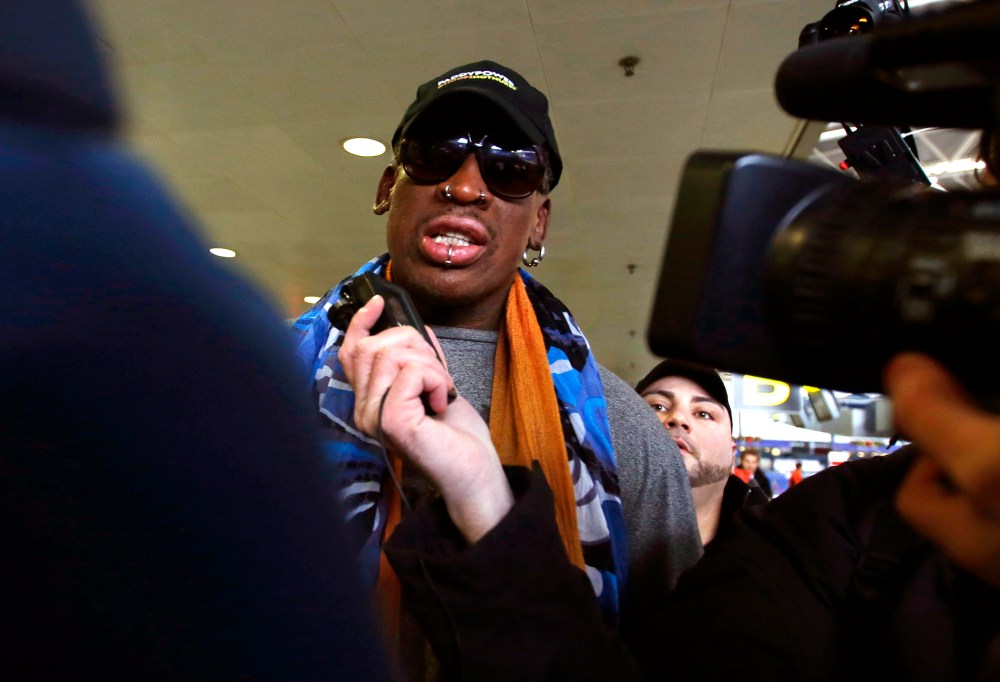 Former NBA basketball player Dennis Rodman talks to the media at the Beijing International Airport in Beijing, Dec. 19, 2013 before leaving for Pyongyang, North Korea.