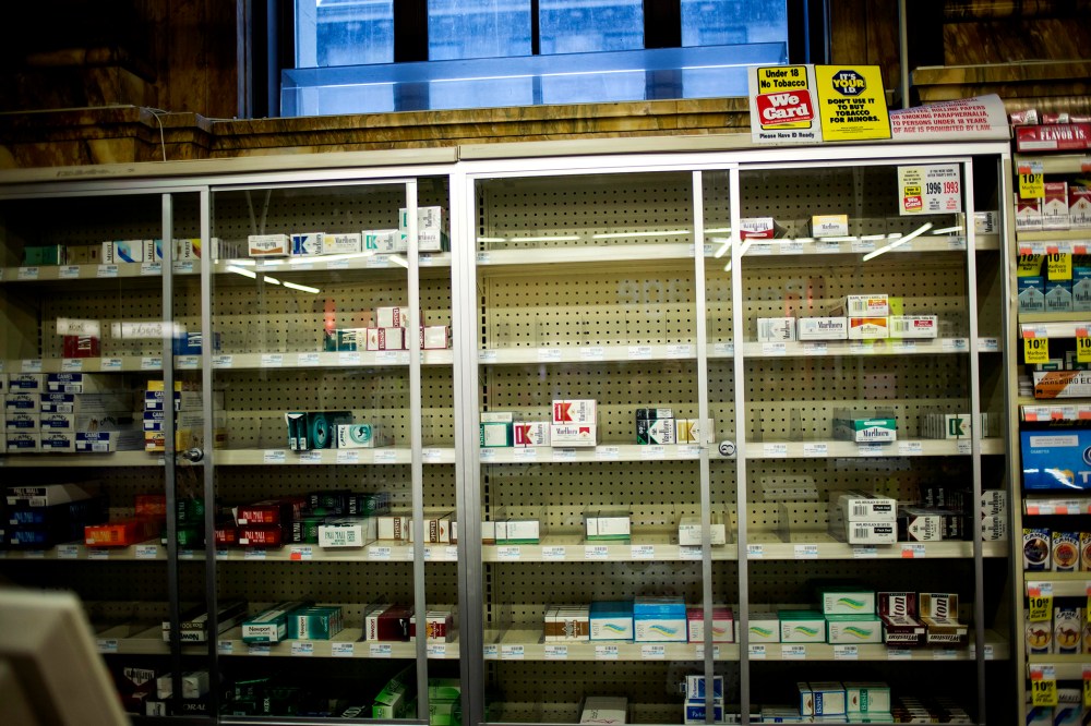 Near empty cigarette shelves are seen at a CVS store in New York February 4, 2014.