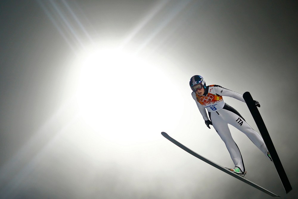 Italy's Evelyn Insam soars through the air in her trial jump during the women's ski jumping individual normal hill event of the Sochi 2014 Winter Olympic Games, at the RusSki Gorki Ski Jumping Center in Rosa Khutor, February 11, 2014.