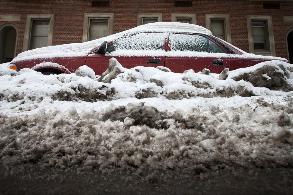 A car that is completely inundated by snow and ice that have accumulated from recent storms is pictured in the Manhattan borough of New York on Feb.16, 2014.