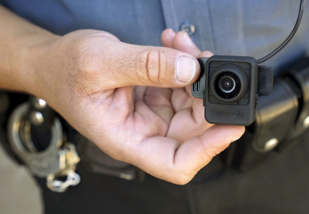 A Colorado Springs police officer poses with a Digital Ally First Vu HD body worn camera outside the police department in Colorado Springs April 21, 2015. (Photo by Rick Wilking/Reuters)