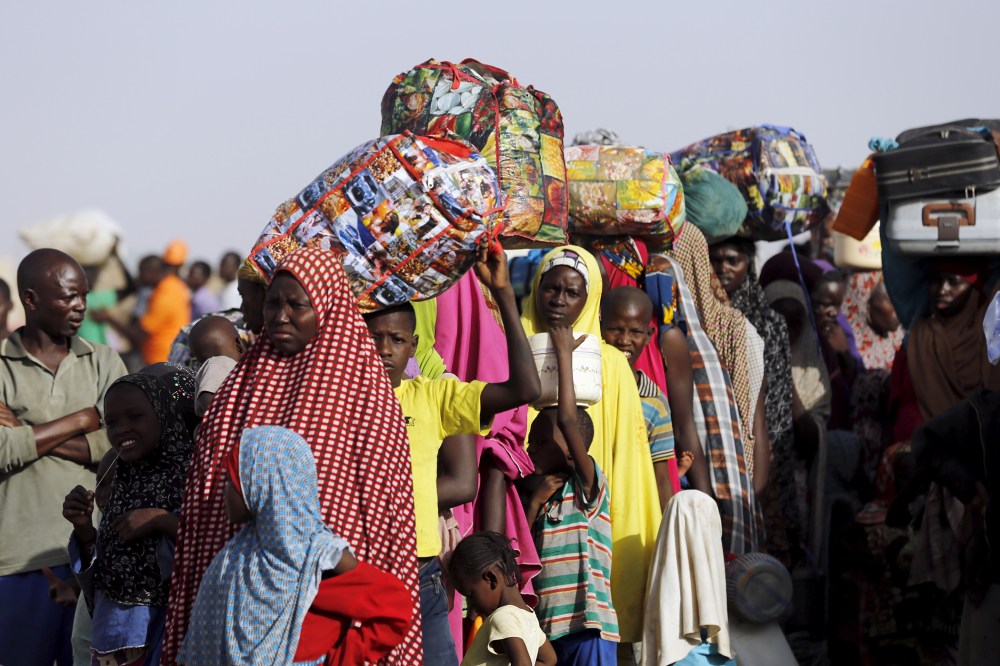 Returnees queue during the evacuation of Nigerians displaced by Boko Haram militants, at a camp for displaced people in Geidam, Yobe state, Nigeria, May 6, 2015. (Photo by Afolabi Sotunde/Reuters)
