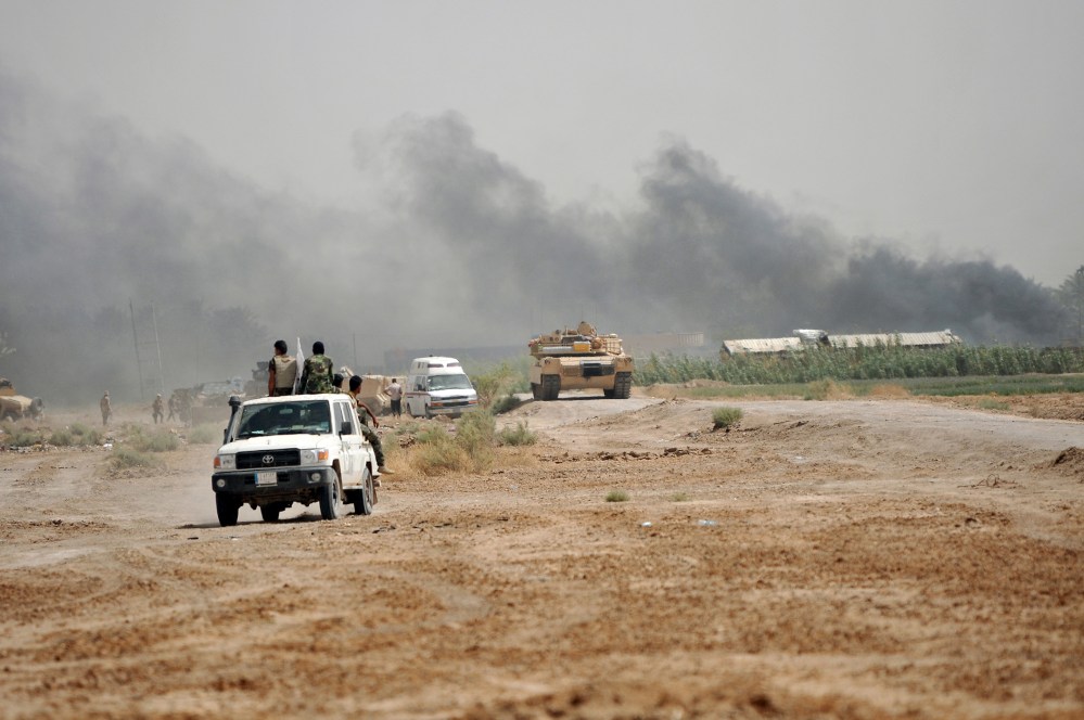 Iraq's Shi'ite paramilitaries and members of Iraqi security forces gather at North of Fallujah in province of Anbar, July 6, 2015. (Photo by Stringer/Reuters)
