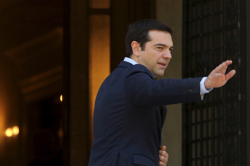 Greek Prime Minister Alexis Tsipras arrives at his office at the Maximos Mansion after a swearing in ceremony of members of his government at the Presidential Palace in Athens, Greece July 18, 2015. (Photo by Yiannis Kourtoglou/Reuters)