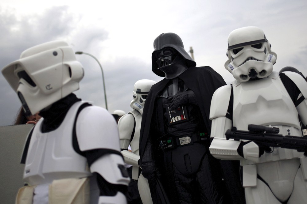 People dress up as "Darth Vader" (C) and "Stormtroopers" from the movie "Star Wars." (Photo by Jon Nazca/Reuters)