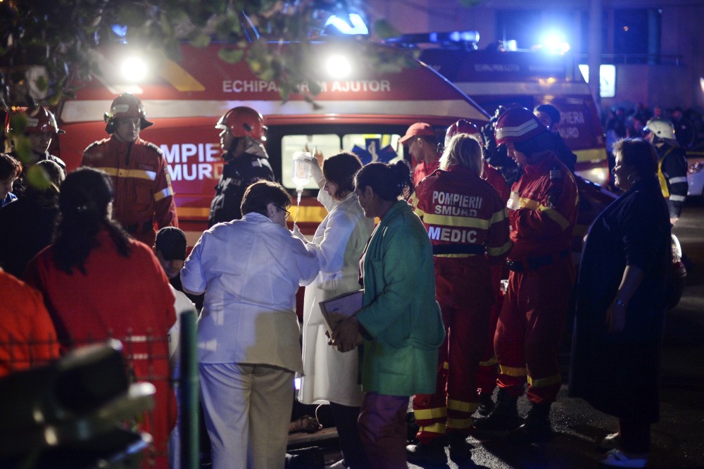 Emergency services work outside a nightclub in Bucharest
