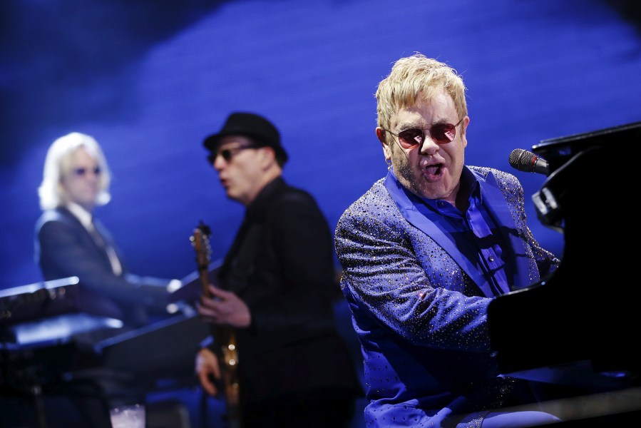 British singer Elton John (R) performs at the 