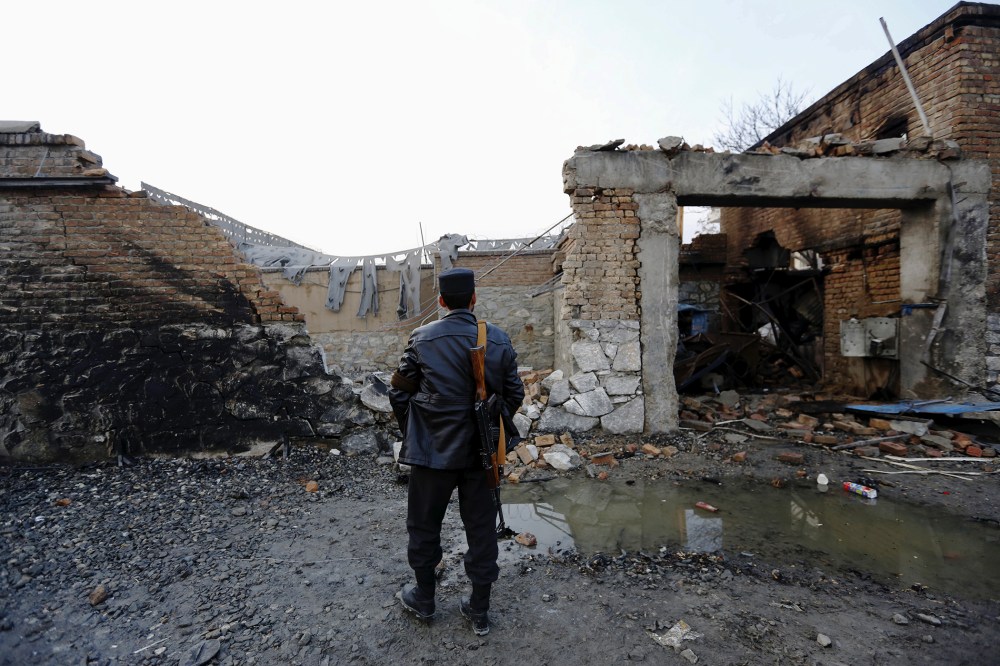 An Afghan policeman stands guard in front of a French restaurant "Le Jardin" after a Taliban suicide attack in Kabul, Afghanistan, Jan. 2, 2016. (Photo by Mohammad Ismail/Reuters)