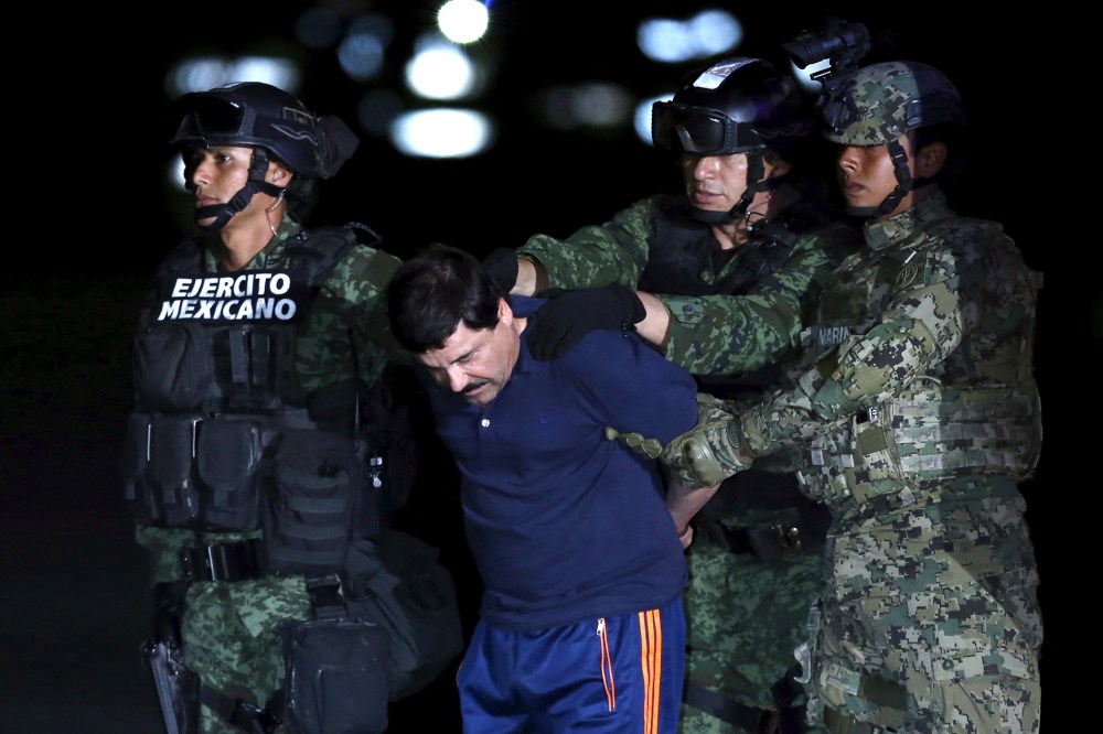Joaquin "El Chapo" Guzman is escorted by soldiers during a presentation at the hangar belonging to the office of the Attorney General in Mexico City, Mexico, Jan. 8, 2016. (Photo by Edgard Garrido/Reuters)