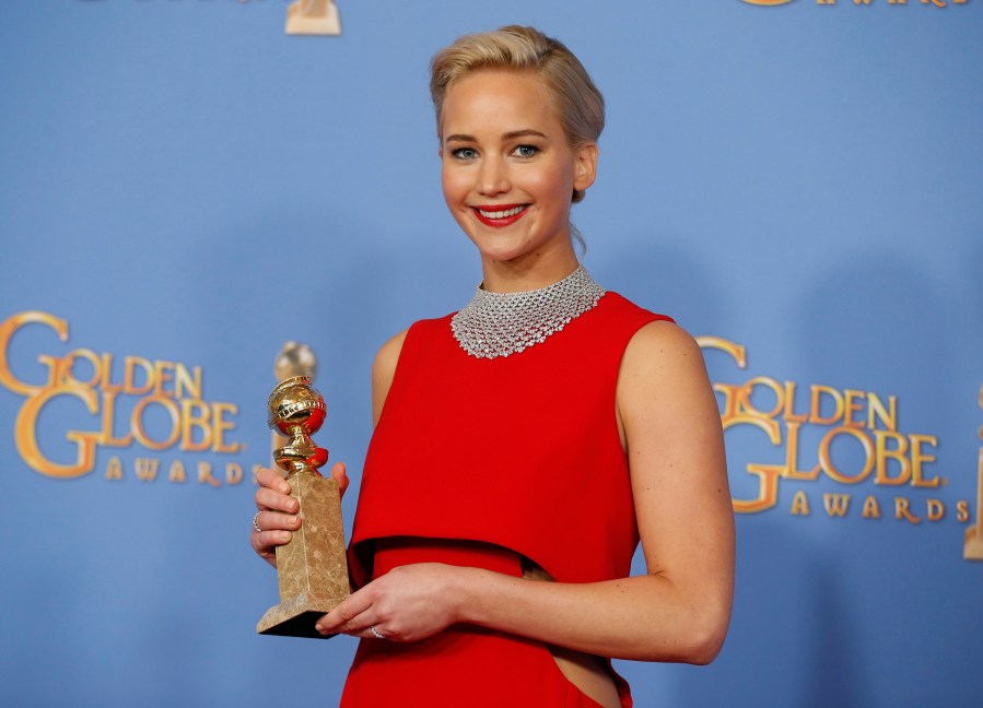 Jennifer Lawrence poses backstage with the award for Best Performance by an Actress in a Motion Picture - Musical or Comedy for her role in 