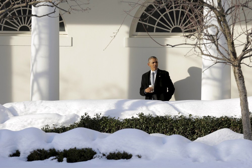 U.S. President Barack Obama waits for members of his staff in the Colonnade as he walks to the Oval Office at the White House in Washington Jan. 25, 2016. (Photo by Joshua Roberts/Reuters)