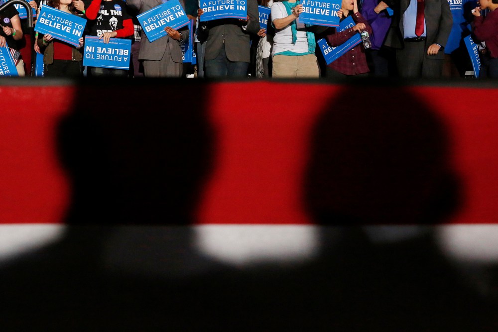 Shadows loom over supporters of Democratic presidential candidate Bernie Sanders at his 2016 New Hampshire presidential primary night rally in Concord, N.H., Feb. 9, 2016. (Photo by Shannon Stapleton/Reuters)