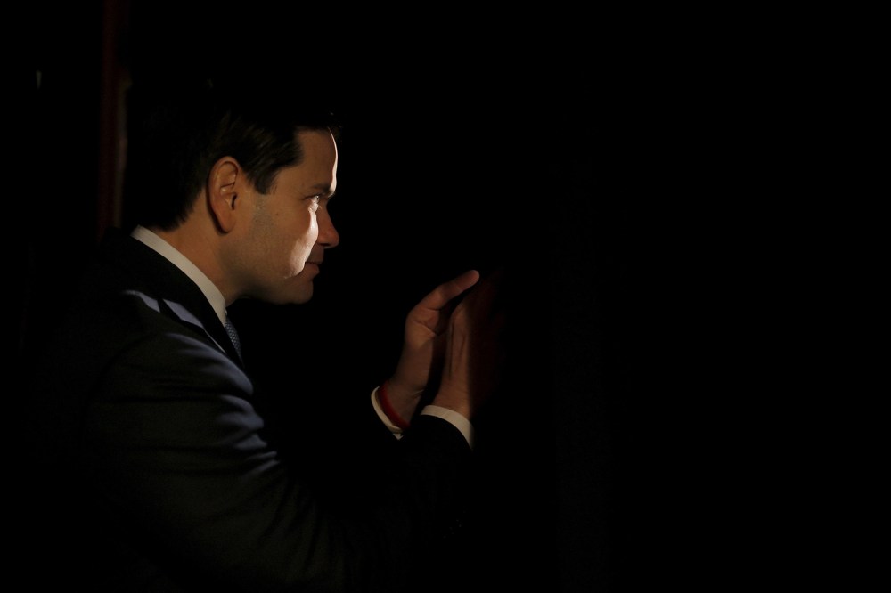 Republican presidential candidate Marco Rubio peeks through curtains before being introduced during a campaign event in Reno, Nev., Feb. 22, 2016. (Photo by Chris Keane/Reuters)