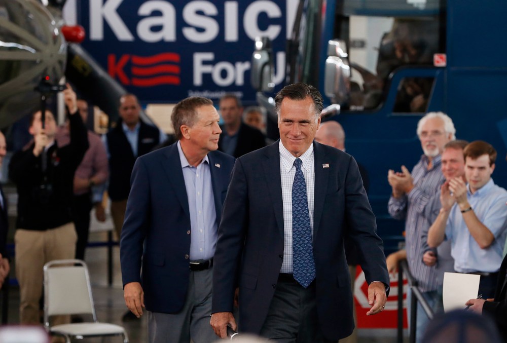 Former Republican U.S. presidential nominee Mitt Romney arrives with current Republican presidential candidate John Kasich inside the MAPS Air Museum for a Kasich campaign rally in North Canton, Ohio, March 14, 2016. (Photo by Aaron P. Bernstein/Reuters)