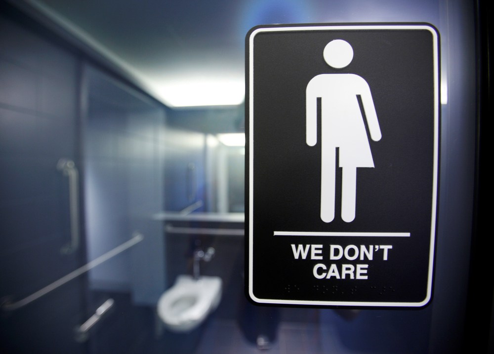 A sign protesting a recent North Carolina law restricting transgender bathroom access adorns the bathroom stalls at the 21C Museum Hotel in Durham, N.C., May 3, 2016. (Photo by Jonathan Drake/Reuters)