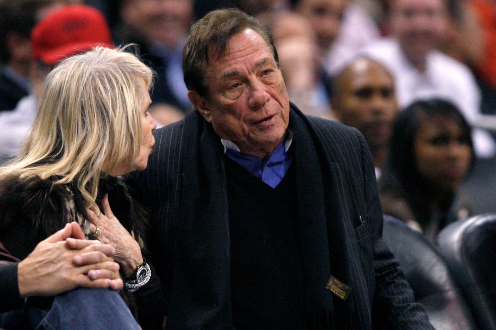 Los Angeles Clippers owner Donald Sterling sits with an unidentified companion as he watches the team play New York Knicks.