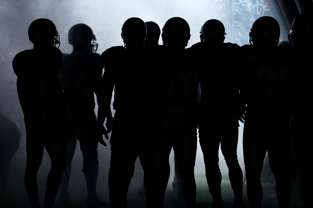 NFL players wait to be introduced to the crowd before playing in a game. (Photo by Mike Blake/Reuters)