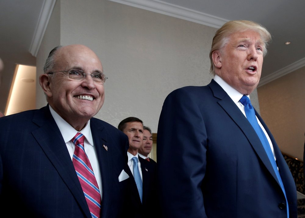 Image: FILE PHOTO: Donald Trump walks with former New York City Mayor Rudolph Giuliani through the new Trump International Hotel in Washington