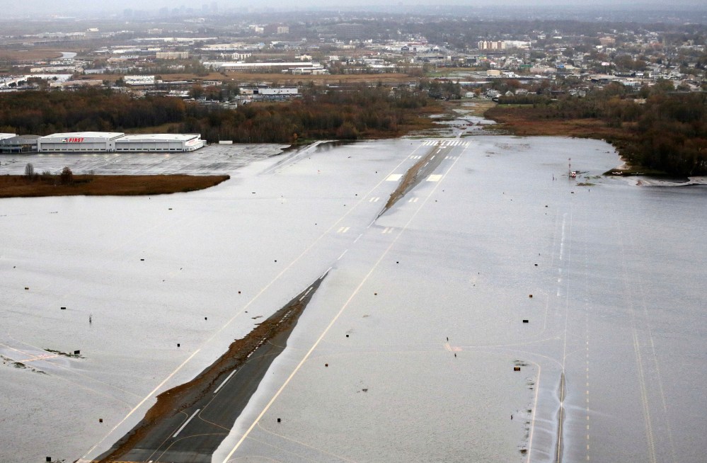 A runway at the Teterboro Airport is flooded in the wake of superstorm Sandy on Tuesday, Oct. 30, 2012, in New York. Sandy, the storm that made landfall Monday, caused multiple fatalities, halted mass transit and cut power to more than 6 million homes...